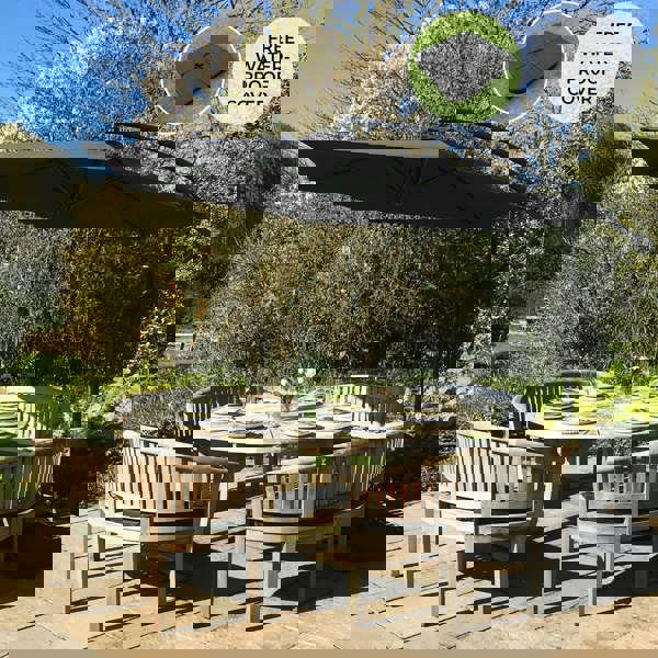 Black cantilever parasol with a square base, featuring a sleek design, providing shade over a round dining table set in a garden