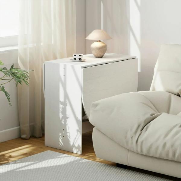 White folding drop-leaf table beside a sofa with countertop and front panel