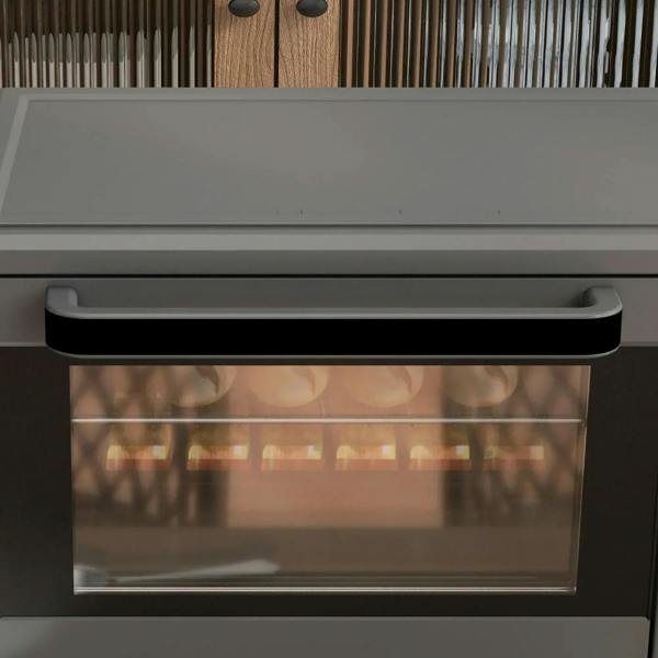 Close-up of grey mini oven glass door window and black handle bar