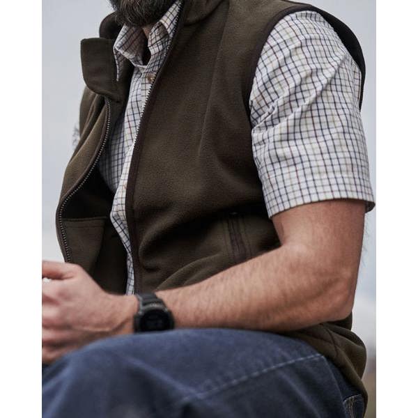 Farmer wearing the Hoggs of Fife Woodhall fleece gilet in green with a short sleeve check shirt