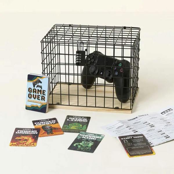 A brightly coloured neon purple and green box for the Game Over escape room board game, featuring graphics of a controller trapped in a cage.