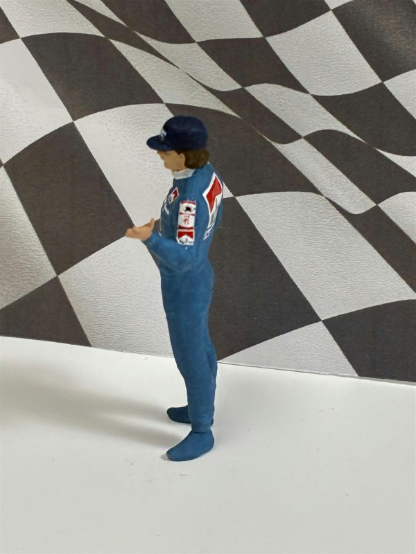a toy figure of a man in a blue uniform