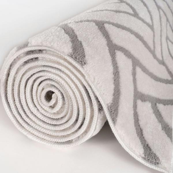 Rolled-up rug with a pattern on a light background