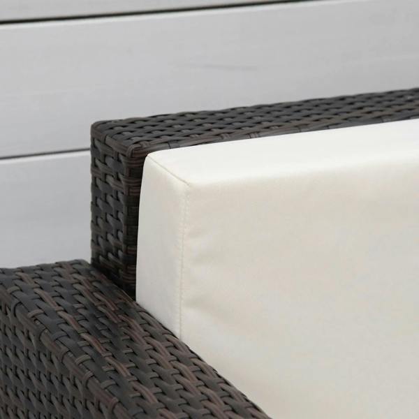 Rattan garden armchair close-up of seat edge and armrest, dark brown weave with white cushion