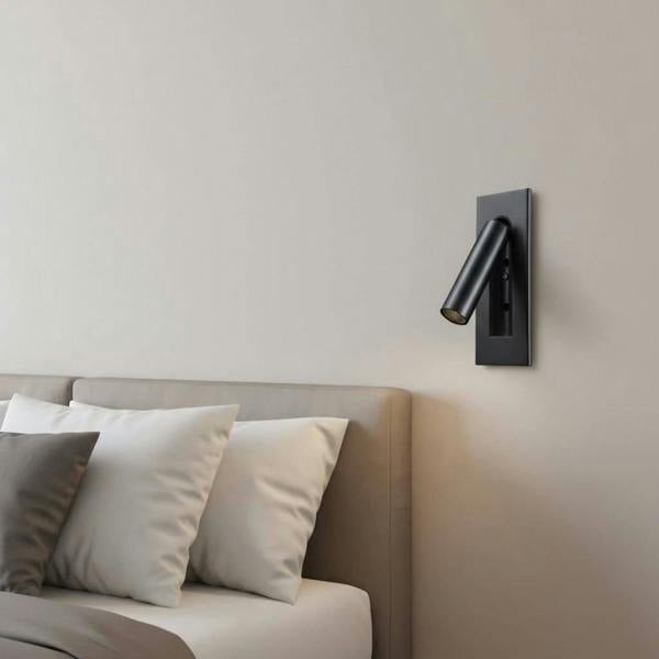 black recessed LED reading wall light mounted on the wall in a modern bedroom next to the bed 