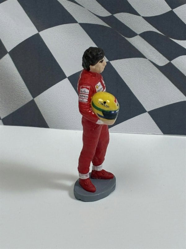 a toy figurine of a man holding a ball