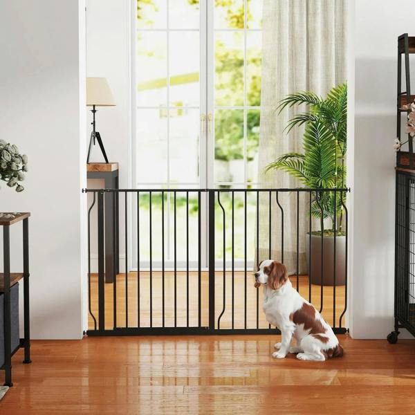 Black extra wide pet safety gate with vertical bars and pressure mounts, dog nearby