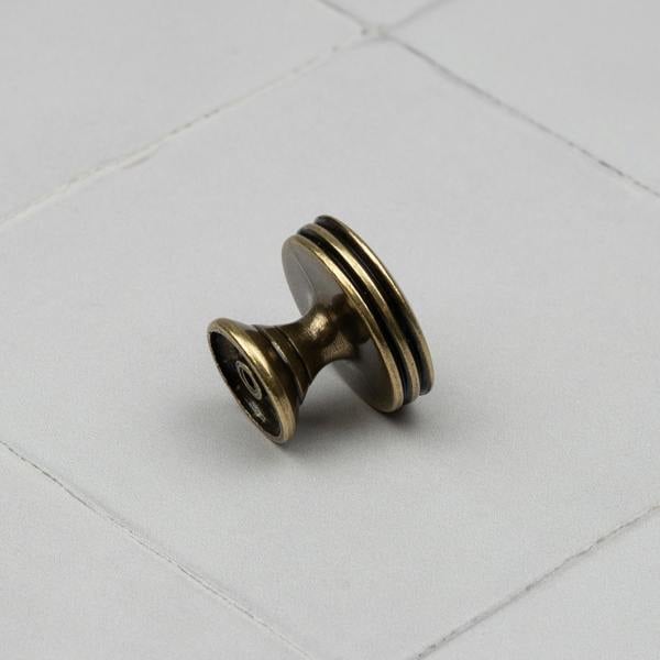 An antique brass round circular knob 