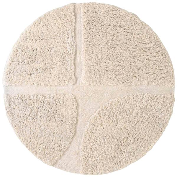Round beige rug with a textured surface on a white background