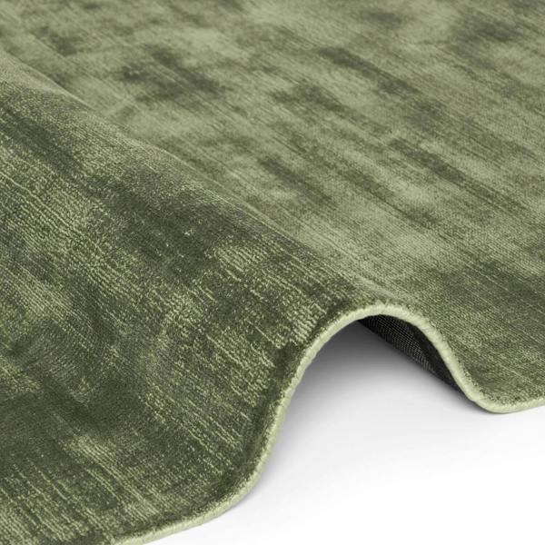 Close-up of a green textured rug on a white background