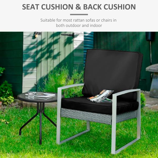 Black seat cushion and back cushion on rattan-style chair, square padded backrest
