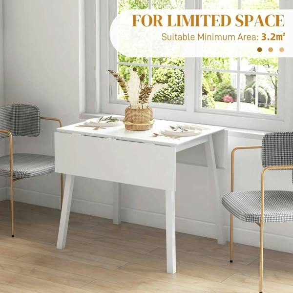 White folding dining table with drop-leaf top in a small dining area