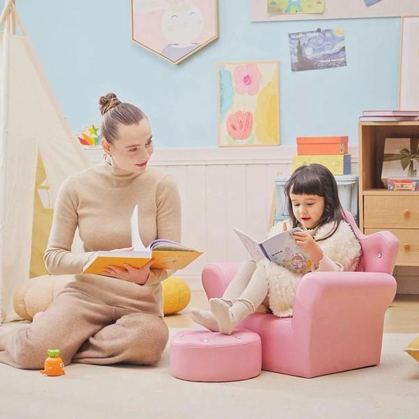 Pink kids armchair with round footstool, child reading while seated