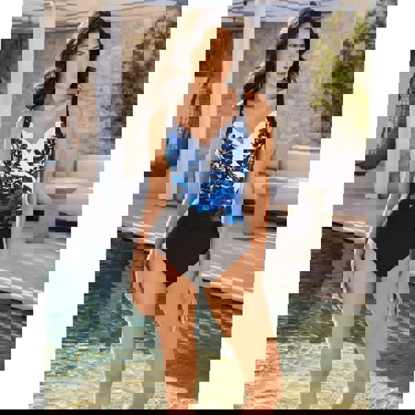 Stylish Miraclesuit Ombra Fiore Sanibel swimsuit in black/multi with blue floral pattern, moderate leg height, Lycra Xtra Life