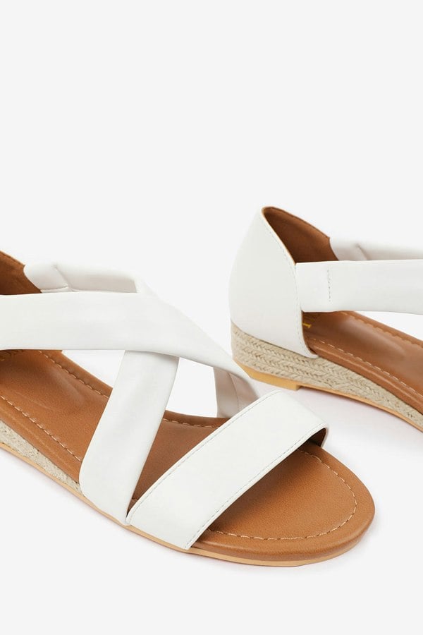 Where's That From Hummingbird Wide Fit Low Wedge Shoes With Cross Over Strap in White