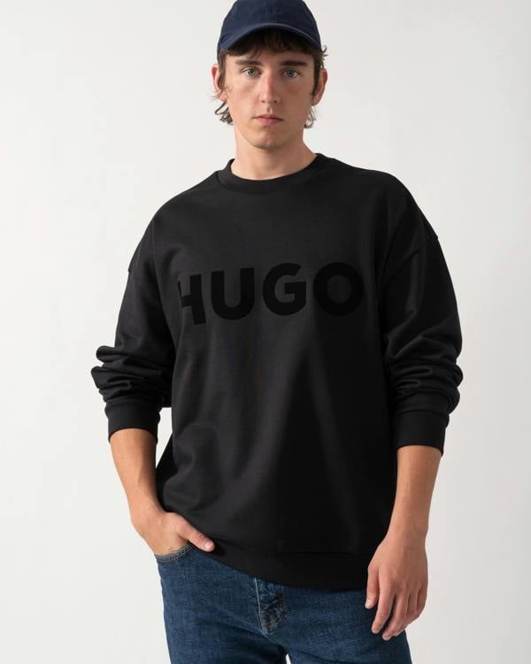 shot of a model wearing a HUGO Dinex Mens Oversized-Fit Sweatshirt in Cotton Terry with Tonal Logo in Black 001
