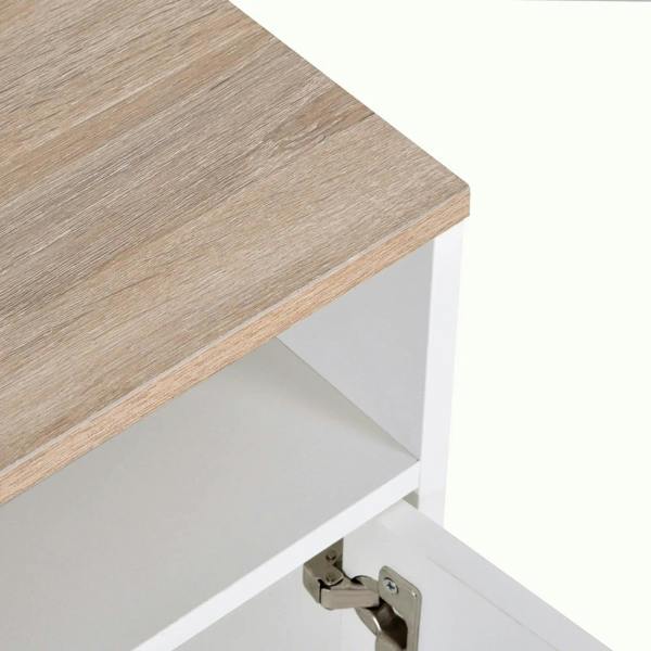 Wood tabletop corner detail of white TV stand with metal hinge visible inside