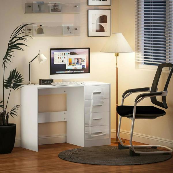 White computer desk with drawers and open center compartment beside office chair