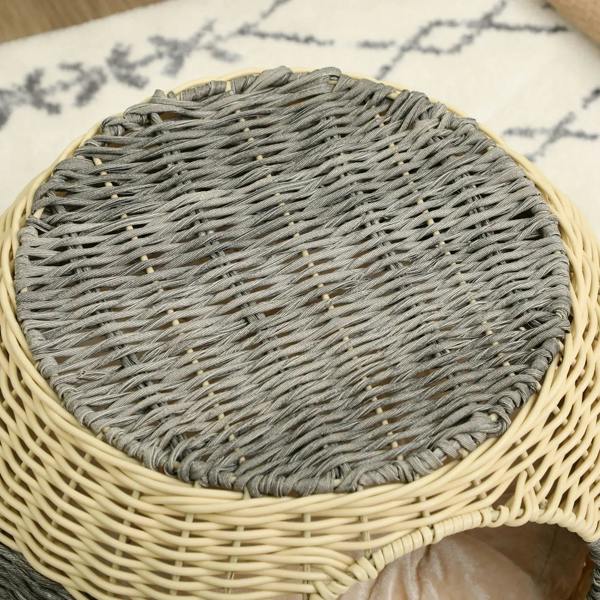 Top view of round wicker cat house with gray woven cushion insert.