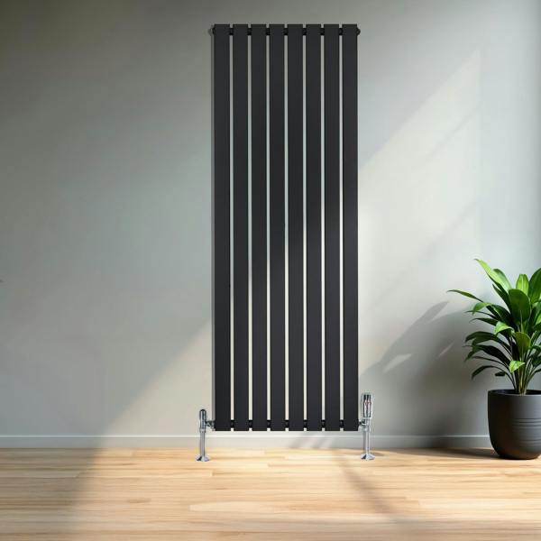 Sleek black flat single column radiator, 1600 x 560mm, featuring vertical lines, mounted on the wall beside a potted plant