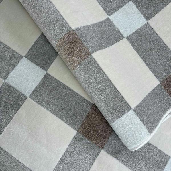 Checkered fabric with gray, white, and brown squares