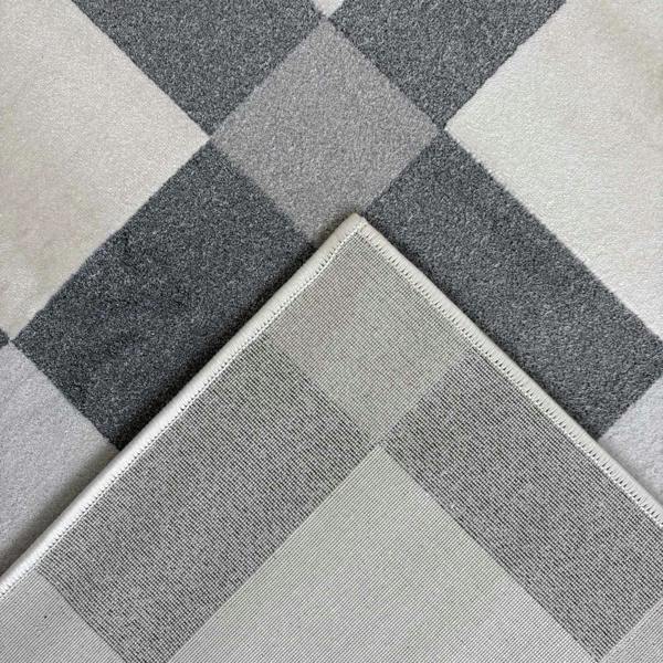 Gray and white checkered patterned rug