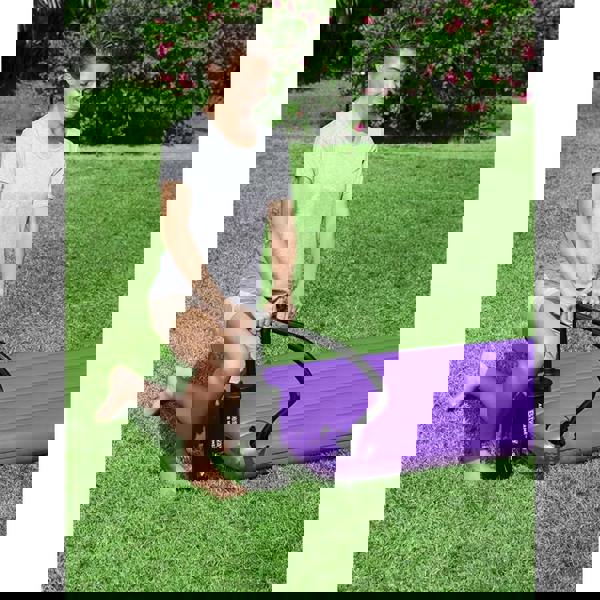 Black Bestway Air Hammer inflation pump with hose inflating purple mattress