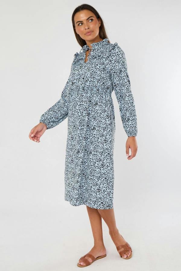 Woman wearing a blue floral dress on a white background