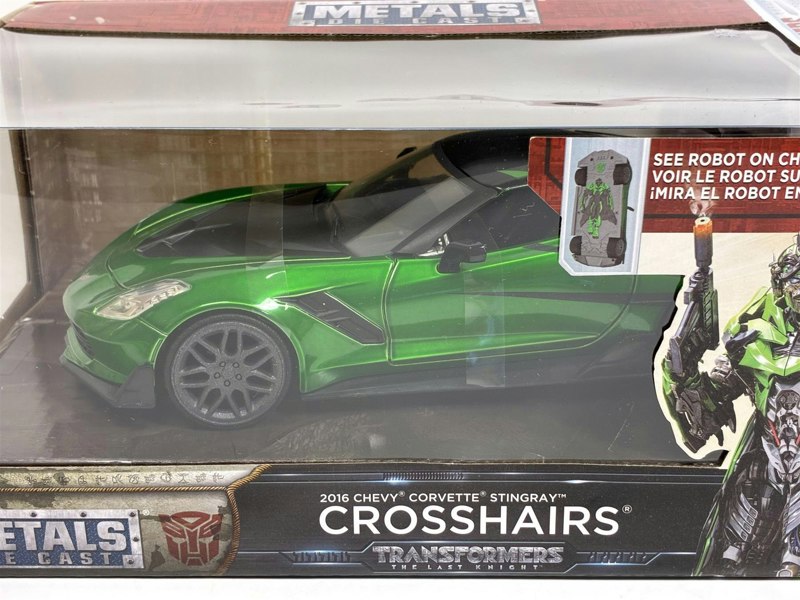 a green toy car in a box