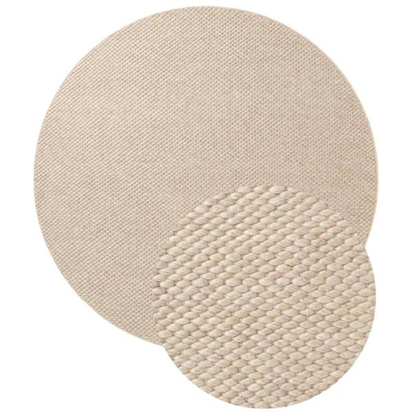Round beige woven rug on a white background