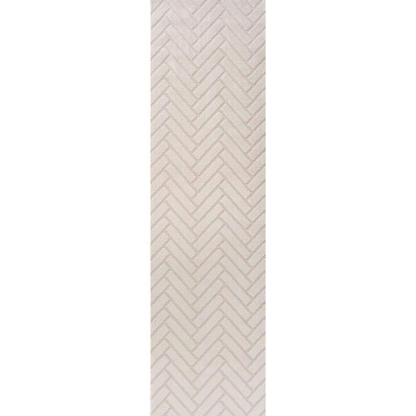 Rectangular area rug with a beige and white chevron pattern on a plain background