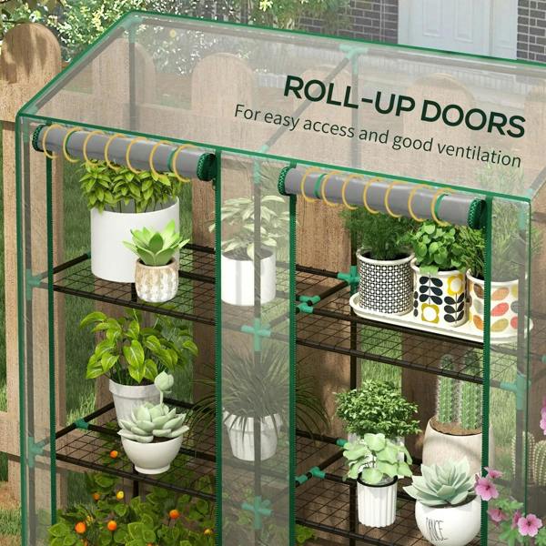 Mini greenhouse with clear roll-up doors and green frame, wire shelves with potted plants