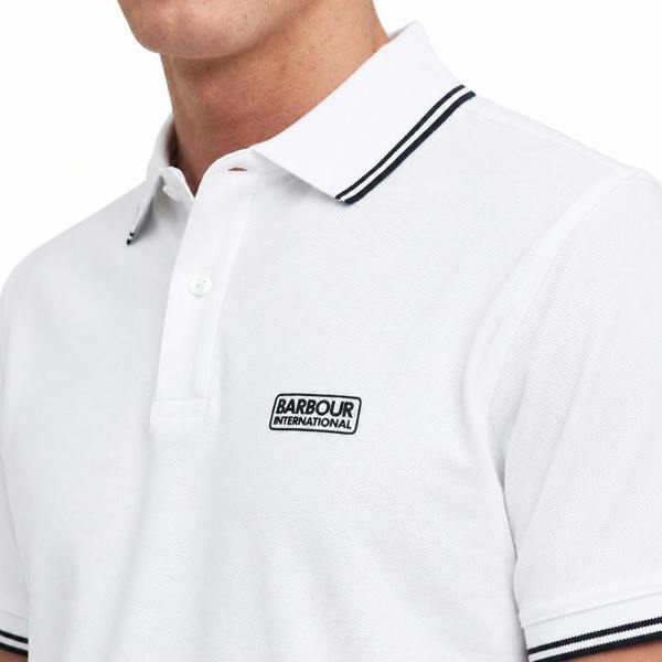 White Barbour International pique polo shirt with black tipped collar and cuffs and a chest logo patch.