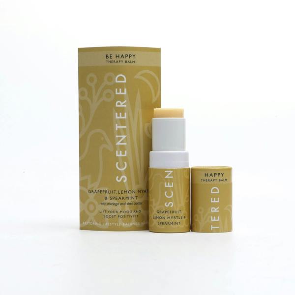 Happy Aromatherapy Balm with cap off and twisted up with eco sleeve packaging on a white background