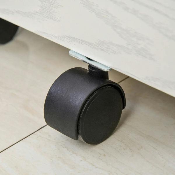 Black caster wheel on the bottom of a white woodgrain filing cabinet