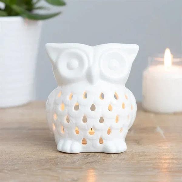 Owl oil burner with lit tealight and warm light shining from teardrop holes