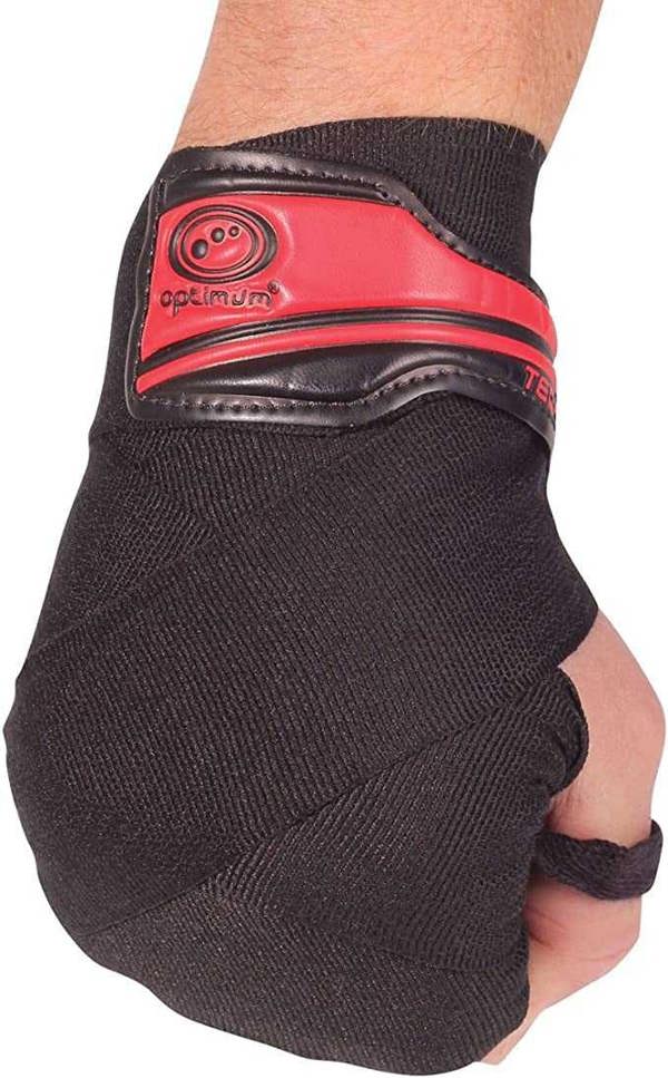 Fist wearing black Optimum Tech Pro boxing wrap with red gel knuckle pad, angled view on white - Optimum