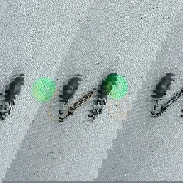 Green clip-on earrings, small round bead design, glossy green finish, silver-tone clip setting, minimalist vintage-inspired jewellery
