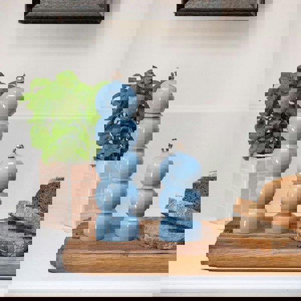 Large and medium Baby Blue Pepper Mills on kitchen counter