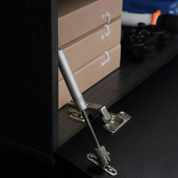 Metal lift hinge hardware for a glossy black TV cabinet storage compartment