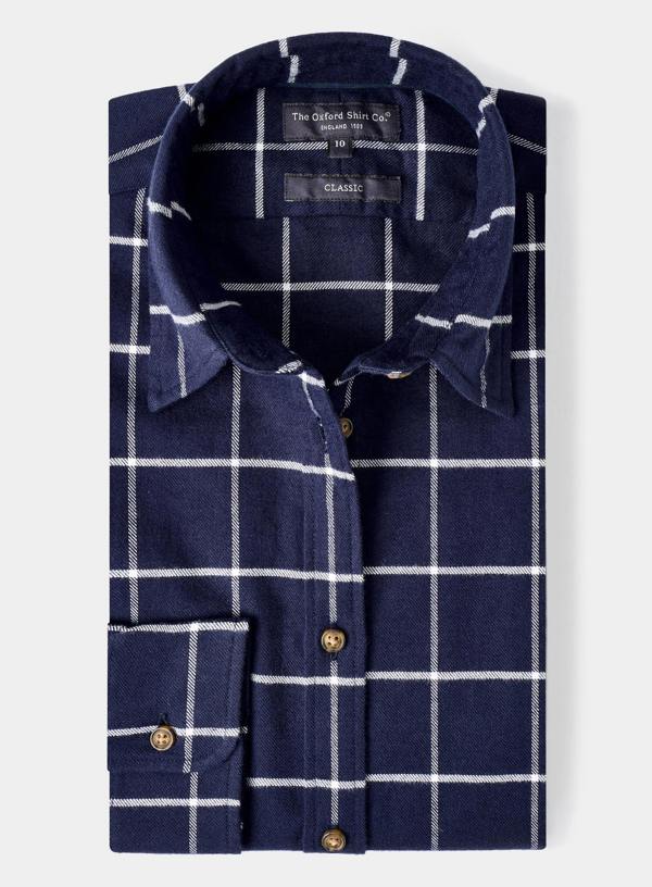 Folded navy blue shirt with white check pattern on a light gray background
