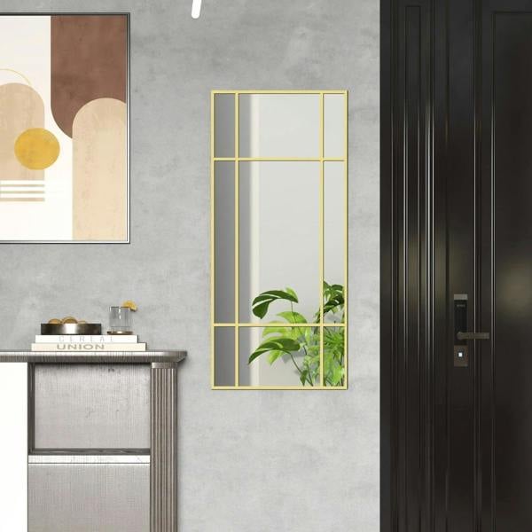 Gold-tone grid wall mirror with rectangular frame and reflective glass panels.