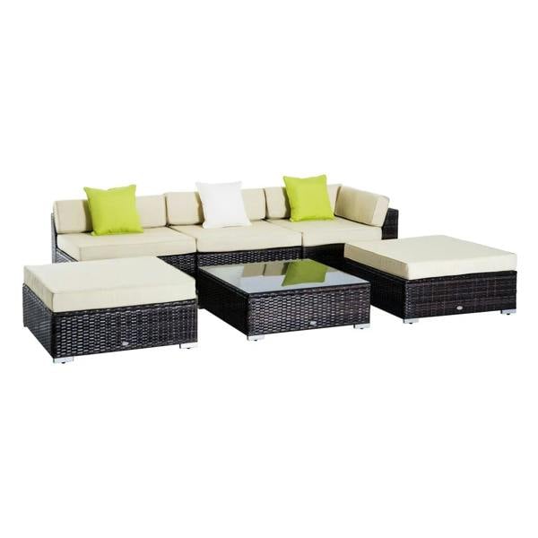 Brown rattan sectional sofa set with white cushions, green pillows, and black wicker coffee table