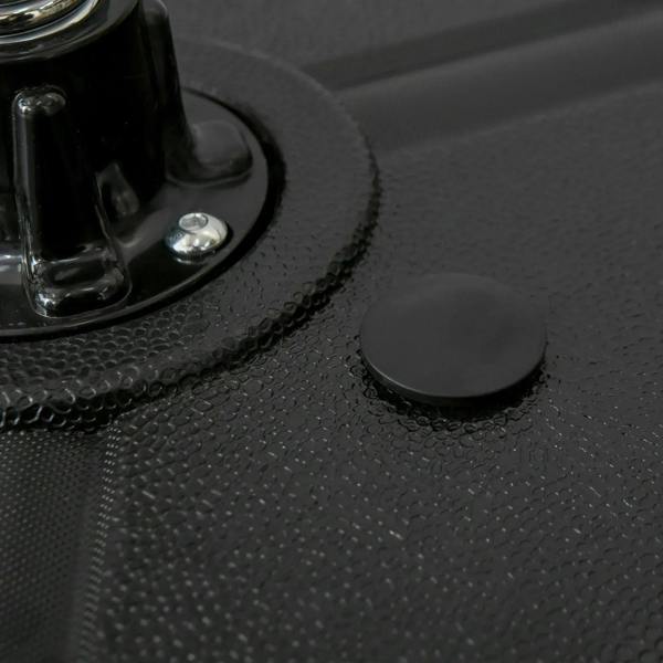 Close-up of black punching bag base with textured surface and rubber foot pad