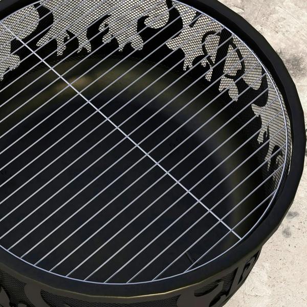 Close-up of black wire mesh cooking grate inside dome fire pit