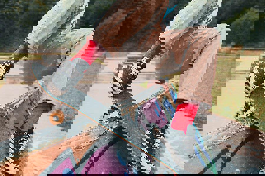 Person skateboarding on a rail wearing red socks with a blurred background