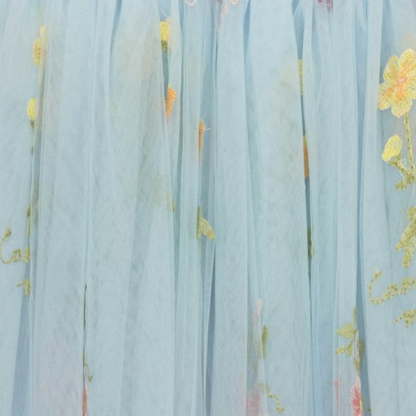 Light blue fabric with floral embroidery in yellow and pink.