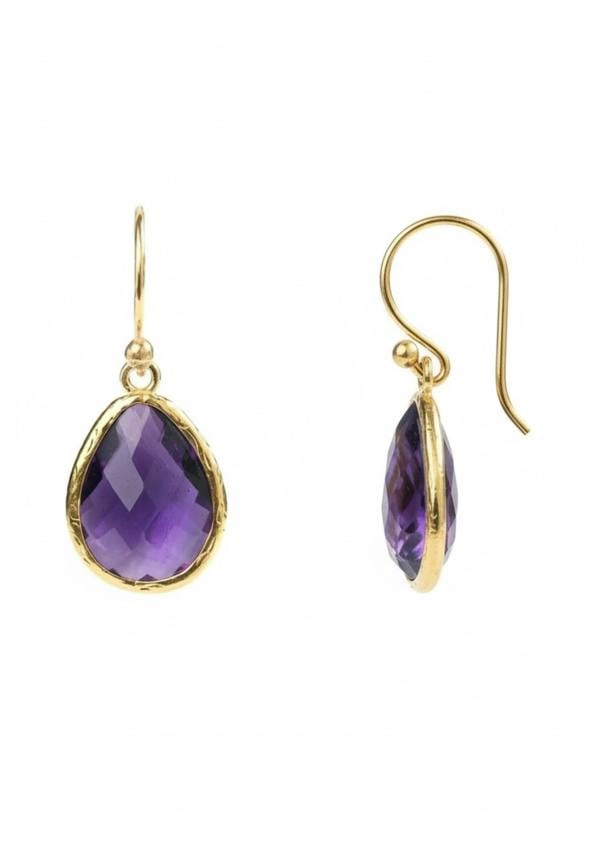 Gold earrings with purple teardrop-shaped gemstones on a white background