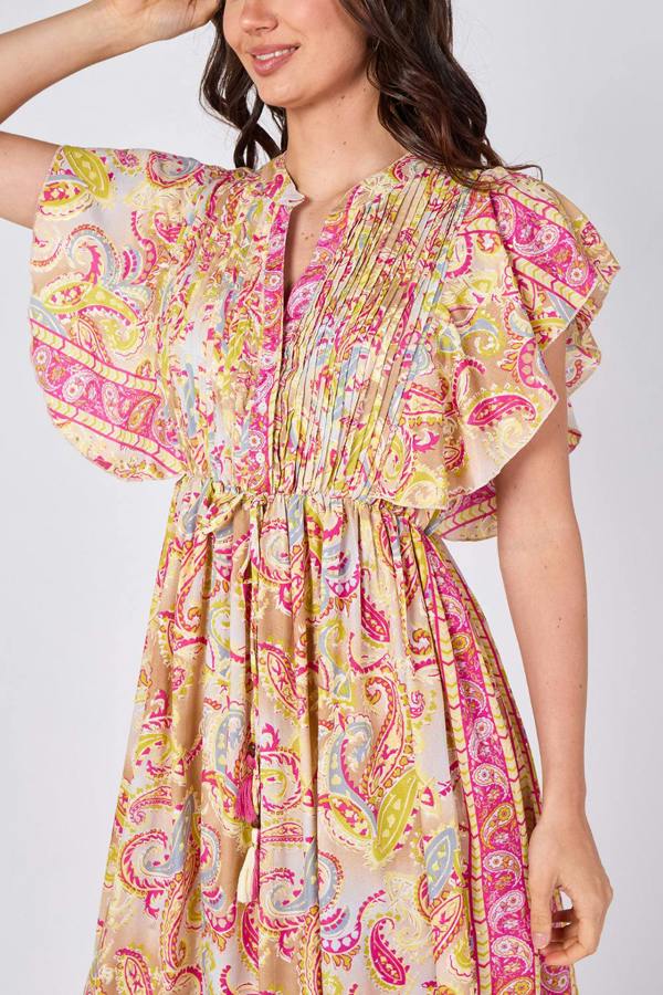 Woman wearing a colorful paisley dress on a white background