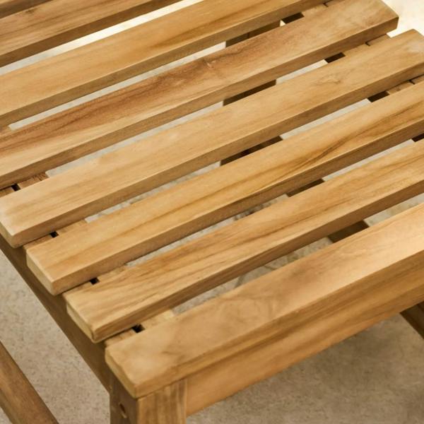 A detailed shot of the teak wood grain on the top rail and slats of the garden armchair.